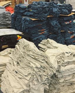 Stacked apparel blanks at Icy Studios warehouse